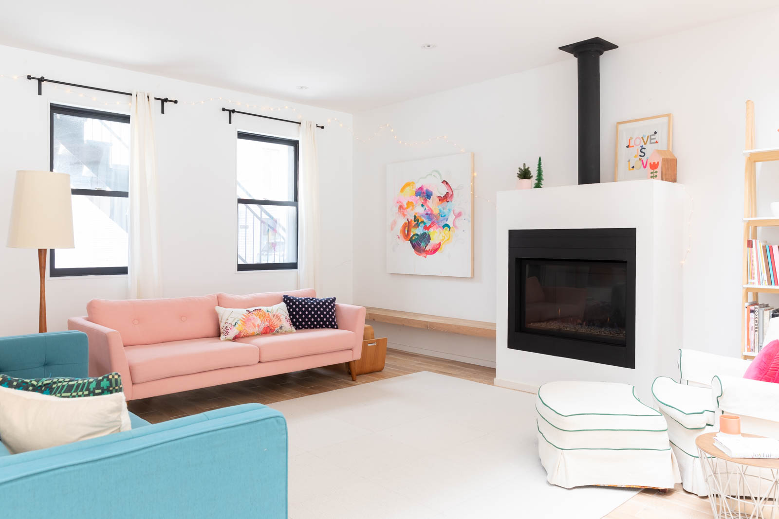 Bright living room with colourful furniture and gas fireplace