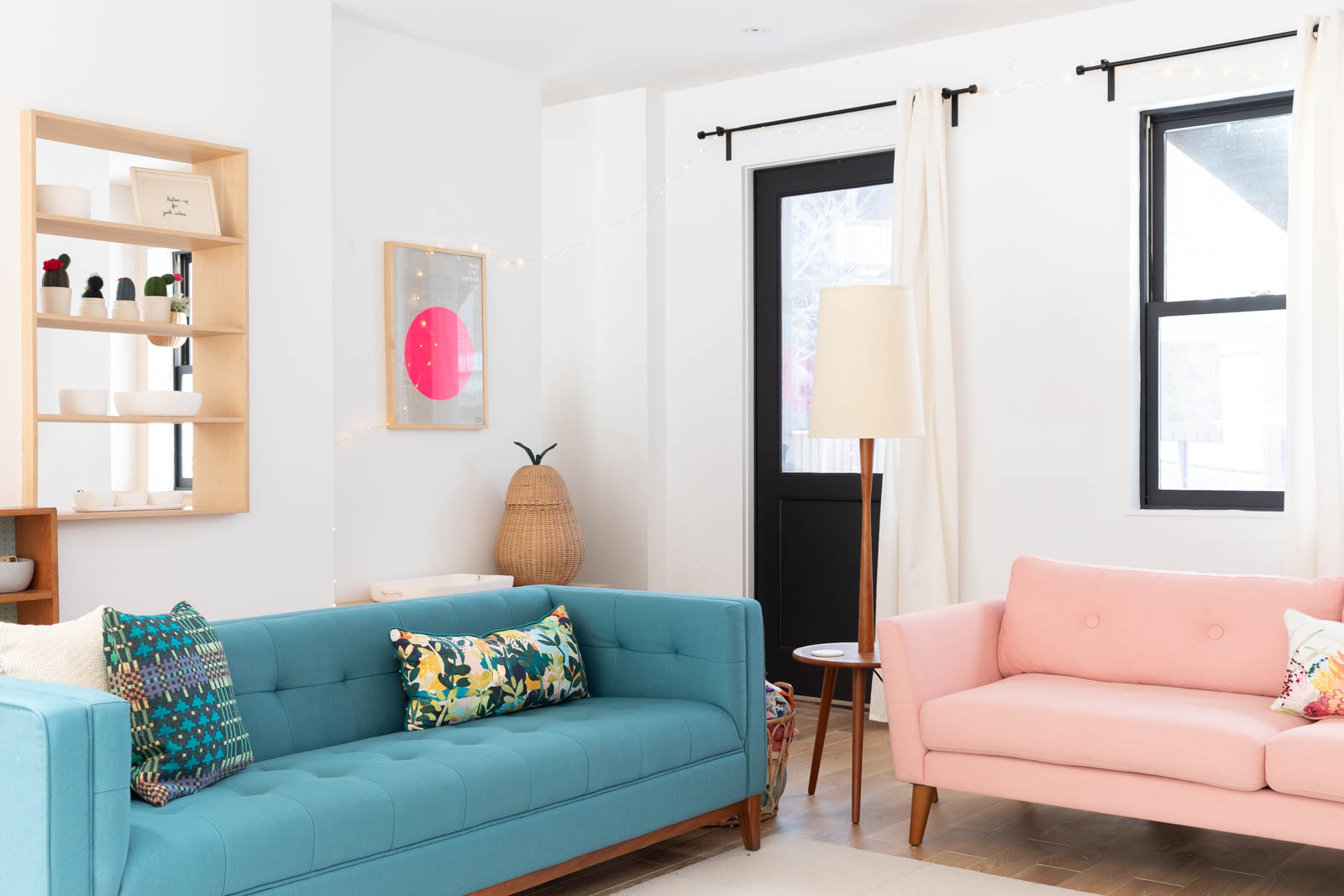 A blue couch and pink couch side by side in the living room