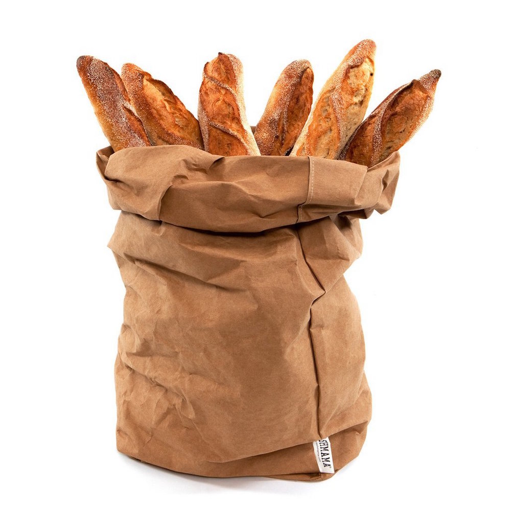 brown washable paper bag with loaves of bread sticking out from the top