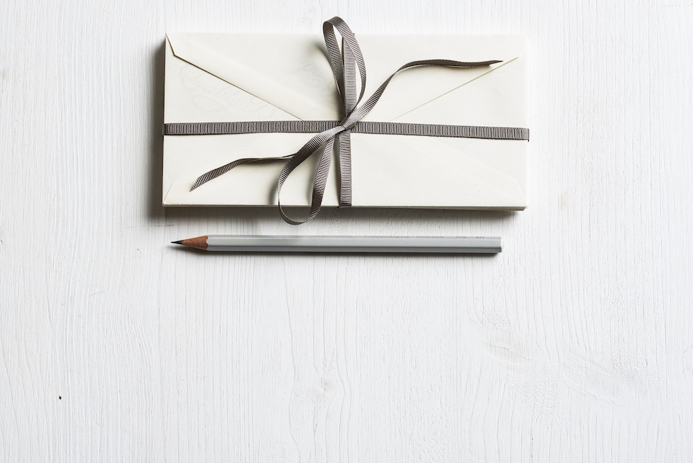 envelope with grey bow on white background