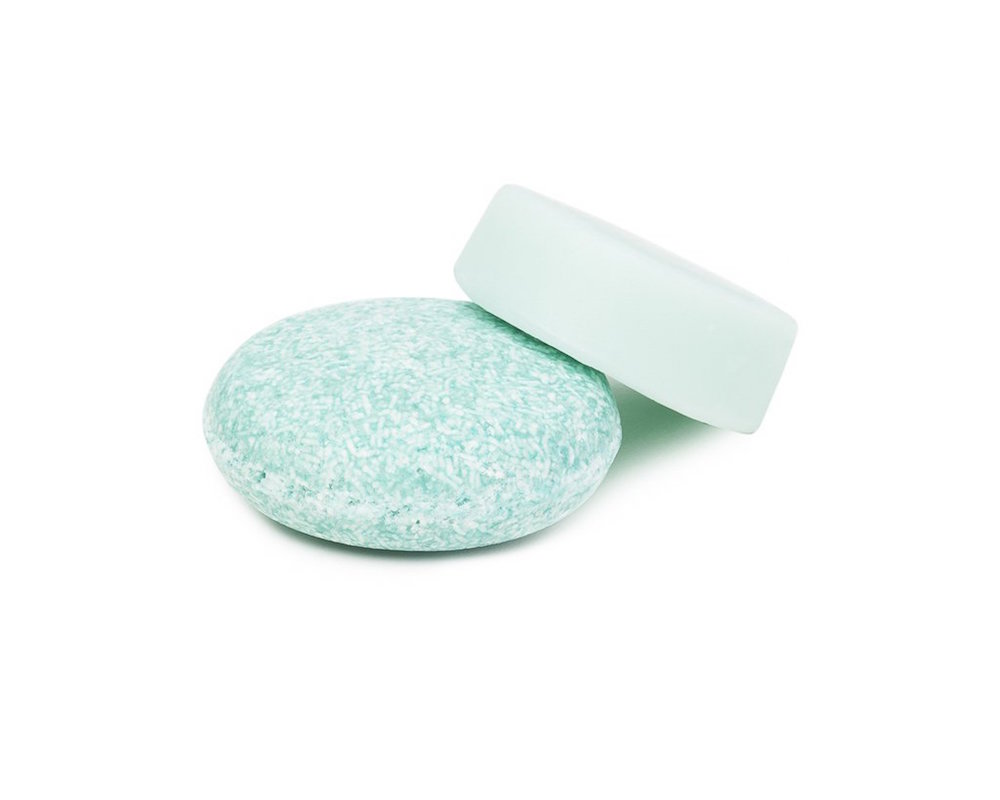 blue shampoo and conditioner bars on white background