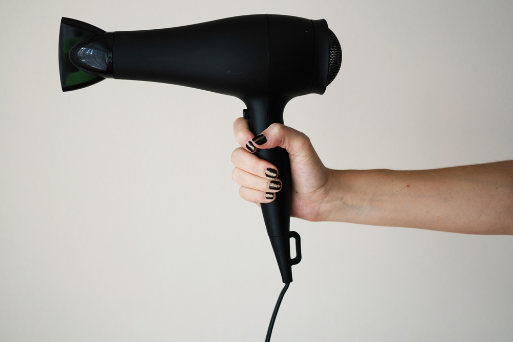 Person holding a hair dryer