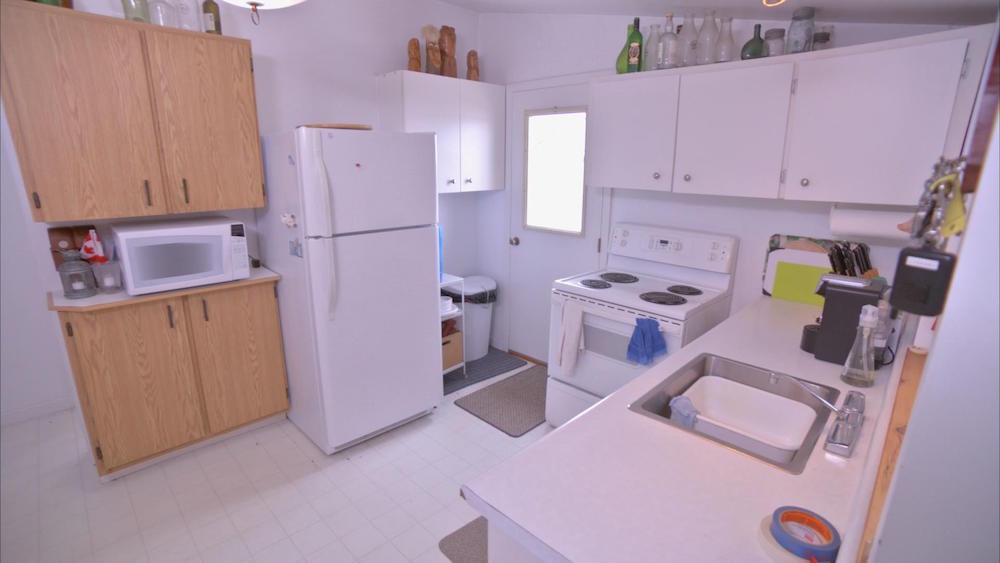 outdated white kitchen with white floor