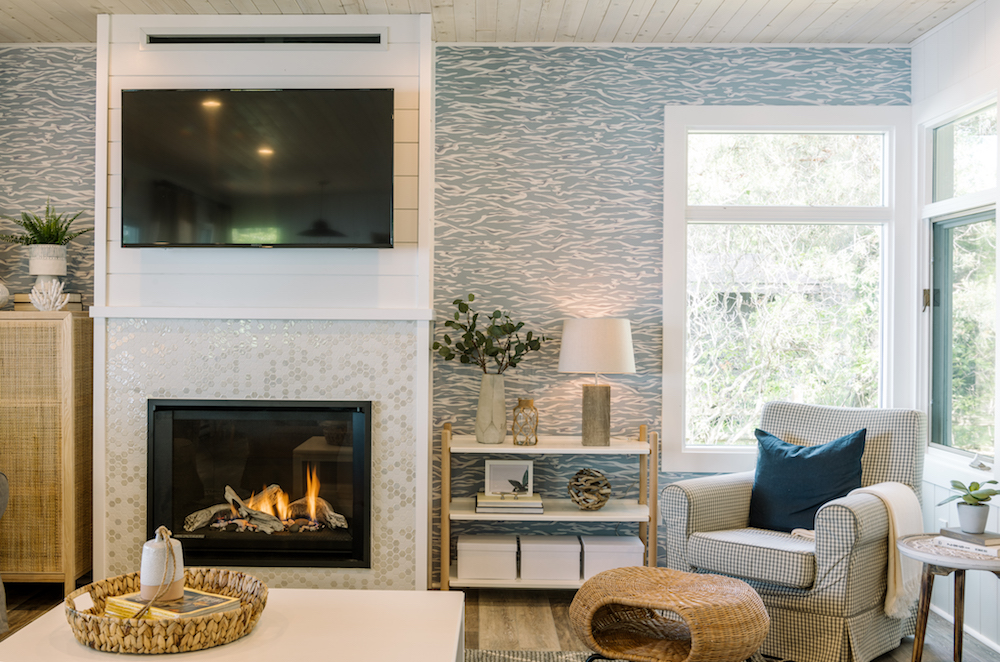 modern beachy living room with wallpaper and fireplace