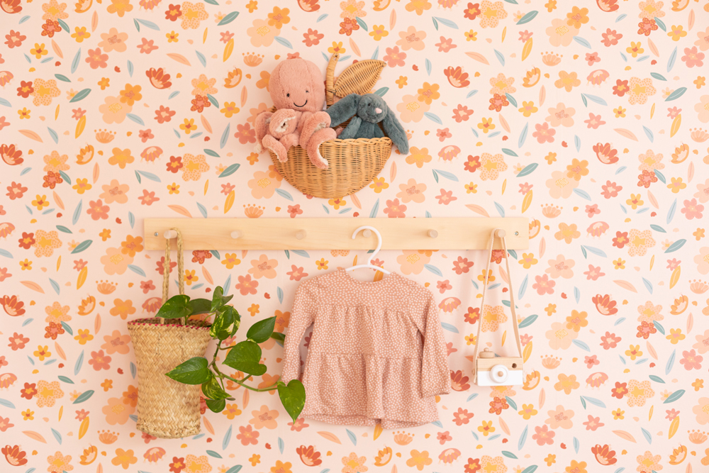 pink nursery with floral wallpaper and hooks