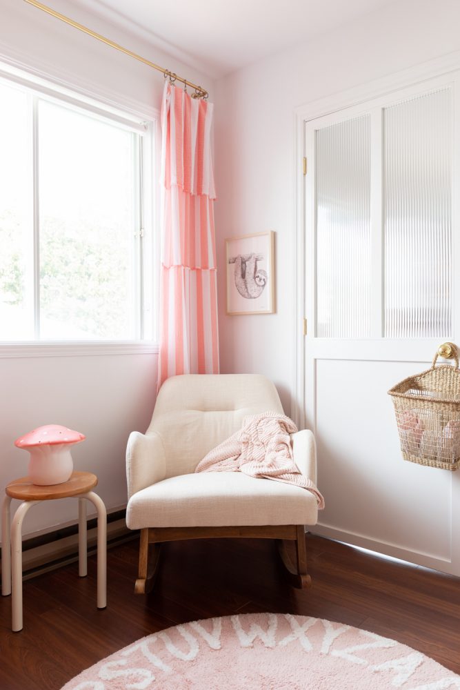 white and pink nursery corner with rocking chair