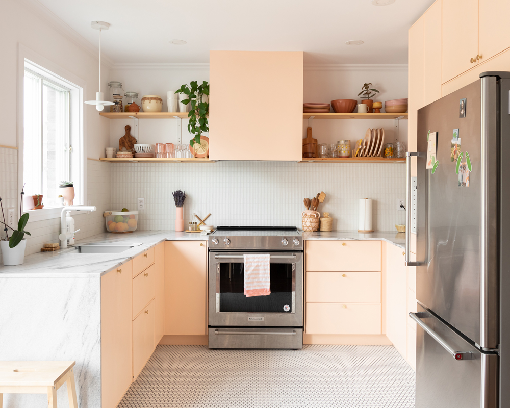 pink and white kitchen with stainless steel appliances