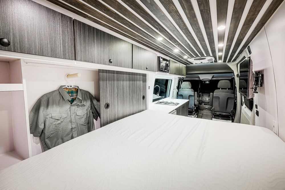 modern grey and white camper van interior with sliding-door closet