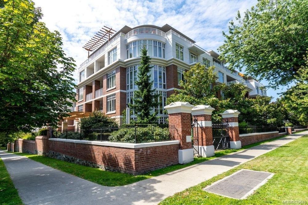 A boutique condo with red bricks and gated landscaping