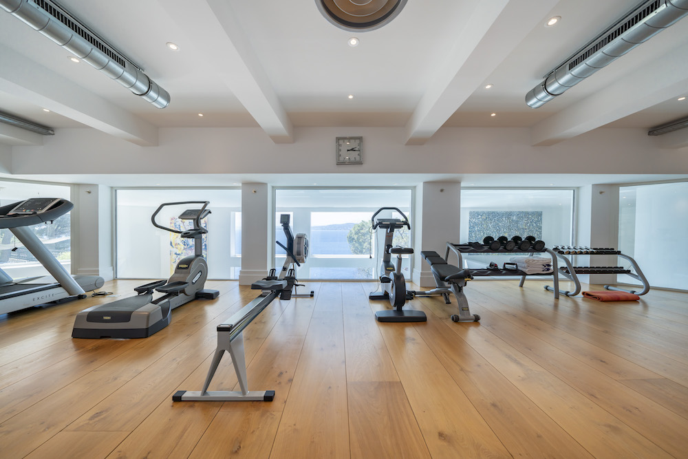 fitness room with wide-plank wood flooring