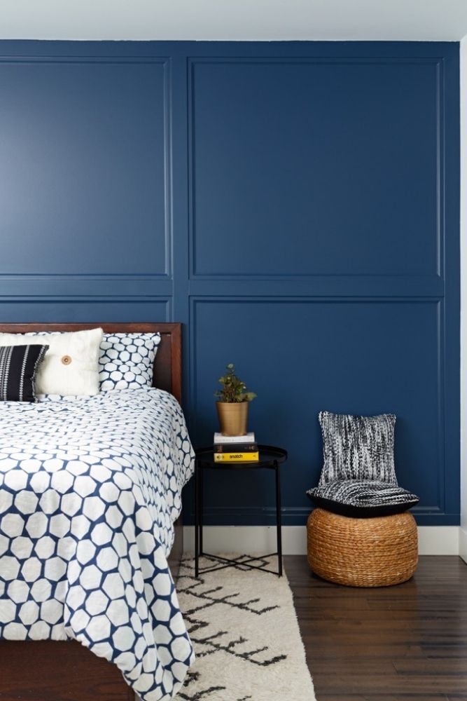Basement bedroom with custom panelling painted deep blue