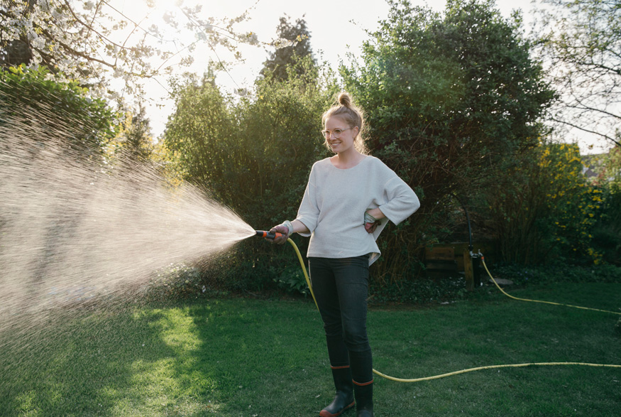 Woman watering a lawn