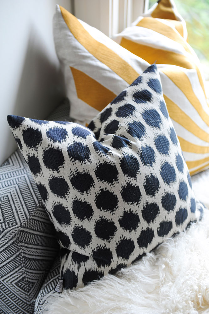 two cushions, black and white dots, yellow and white stripes