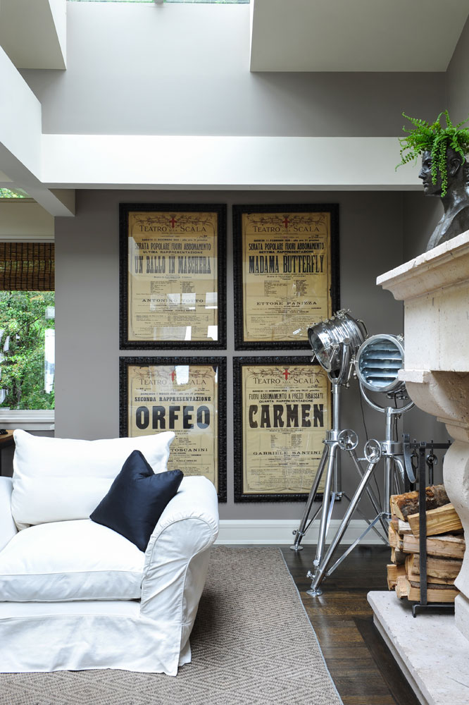four framed opera posters in living room corner