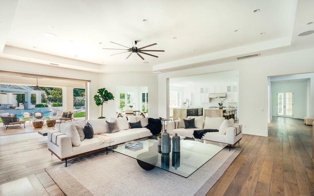 Family room with white couches and glass coffee table