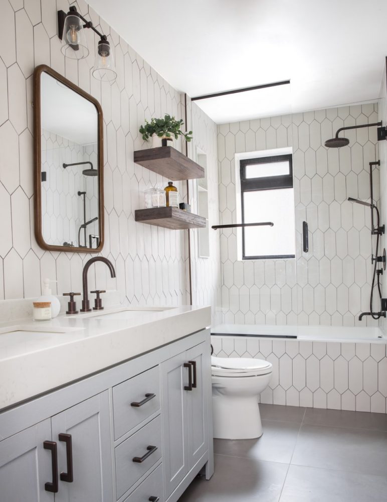 White vanity in bathroom covered in white octagonal tile