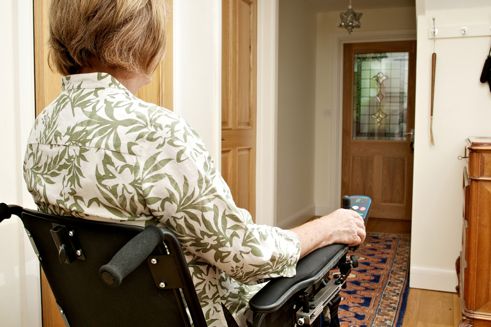Woman in wheelchair at front door