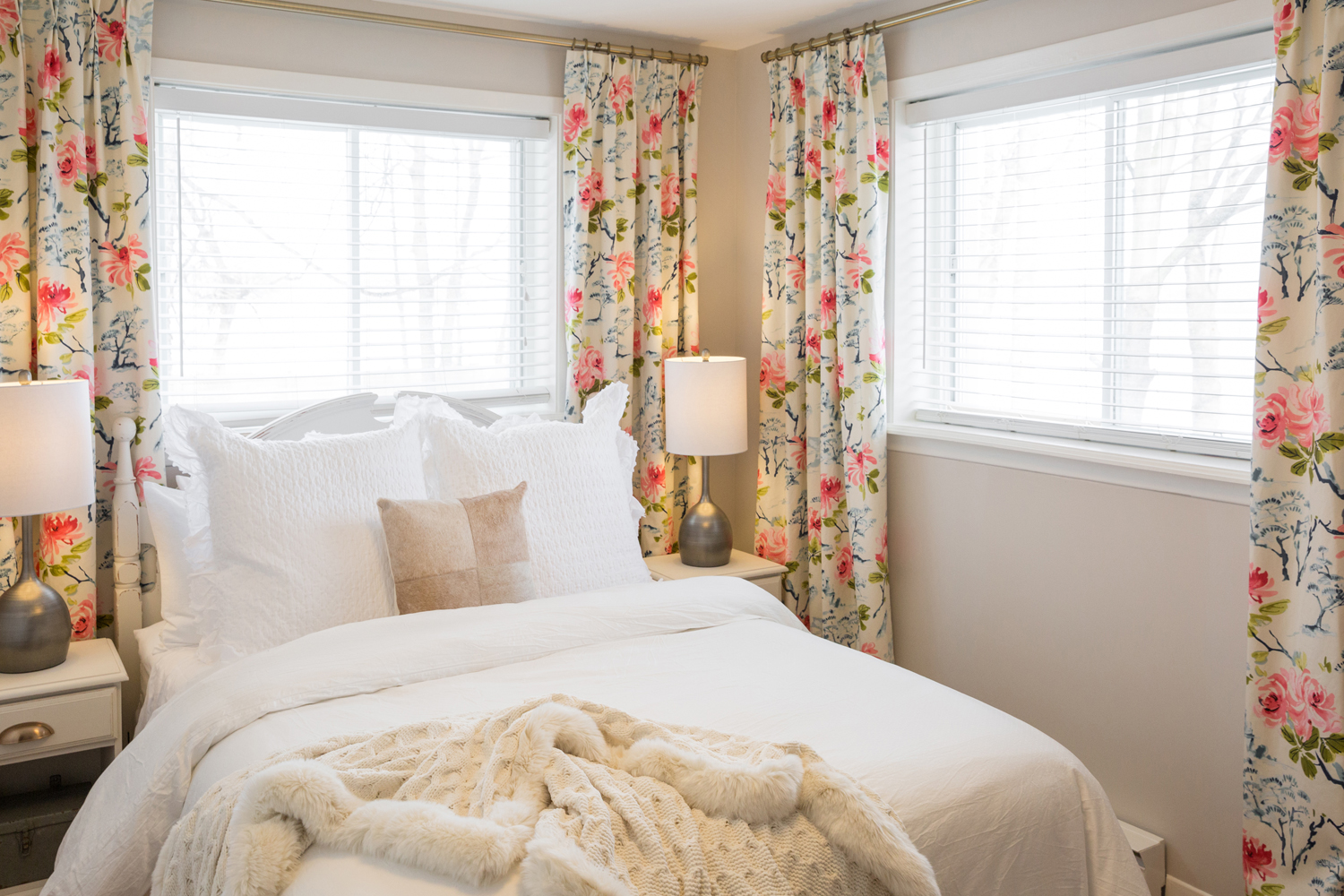 Busy floral curtains in guest bedroom