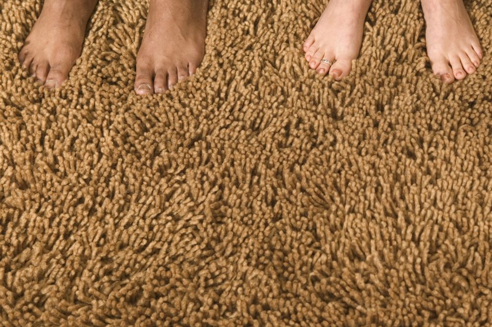 Bare feet on a brown shag carpet