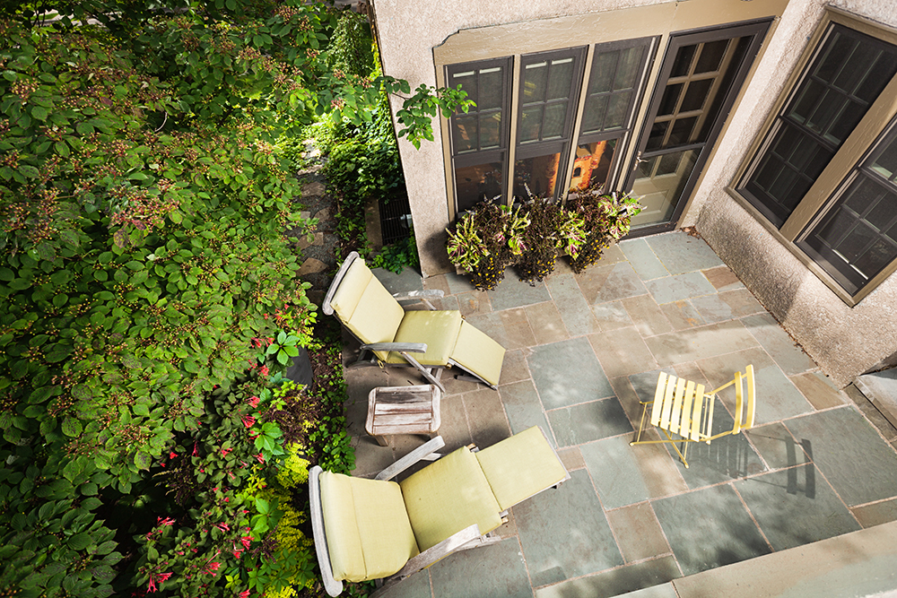 Small backyard with greenery and patio furniture