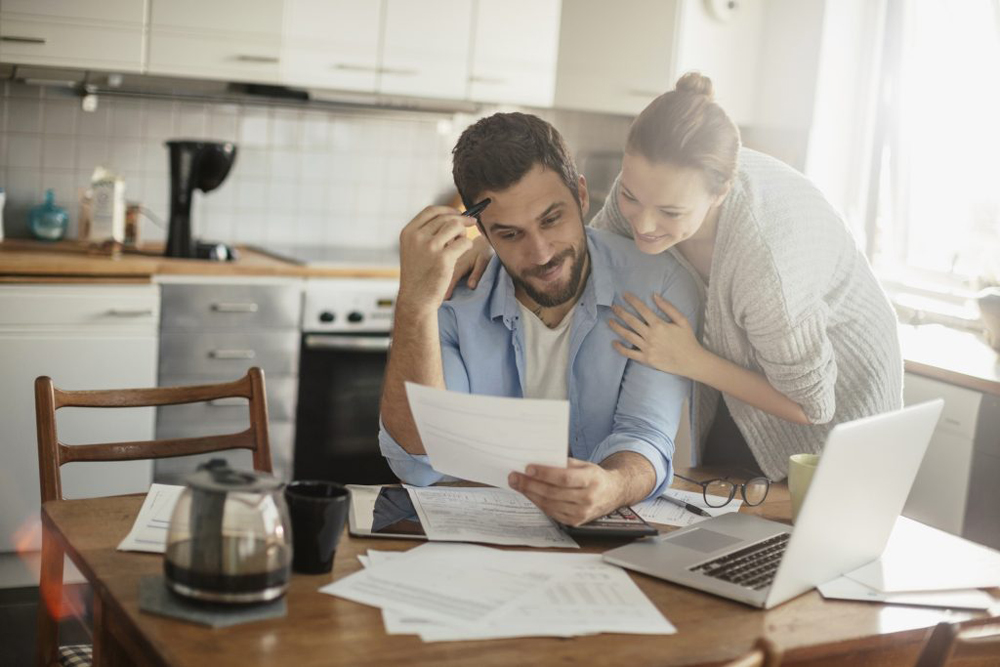 Couple looking over finances at kitchen table