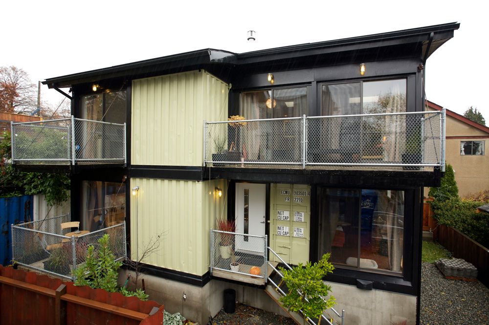 two-storey container home with plenty of windows and deck space