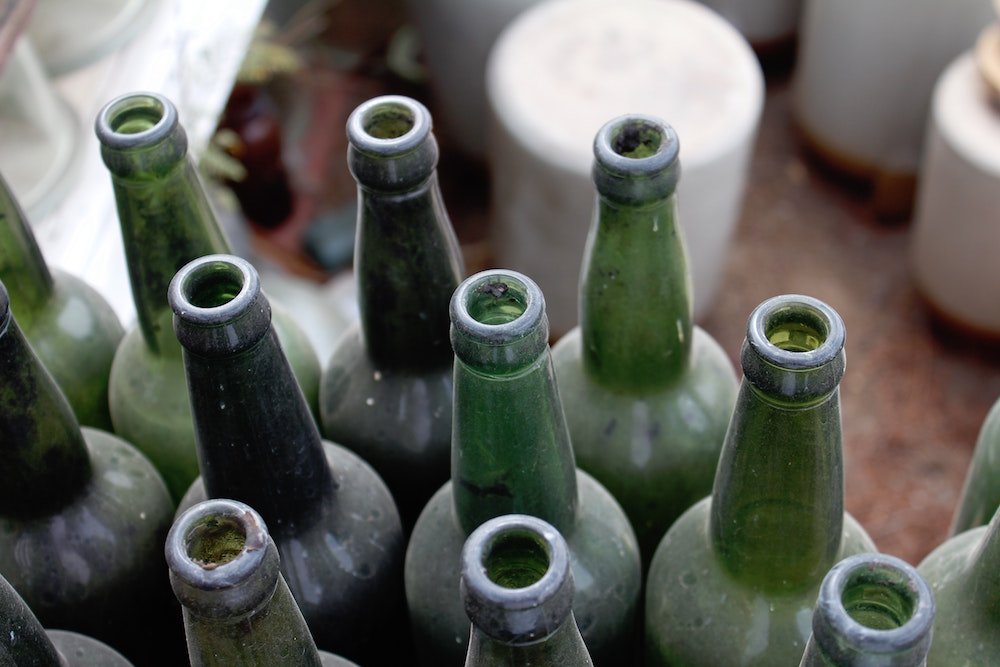 rows of dusty green empty bottles