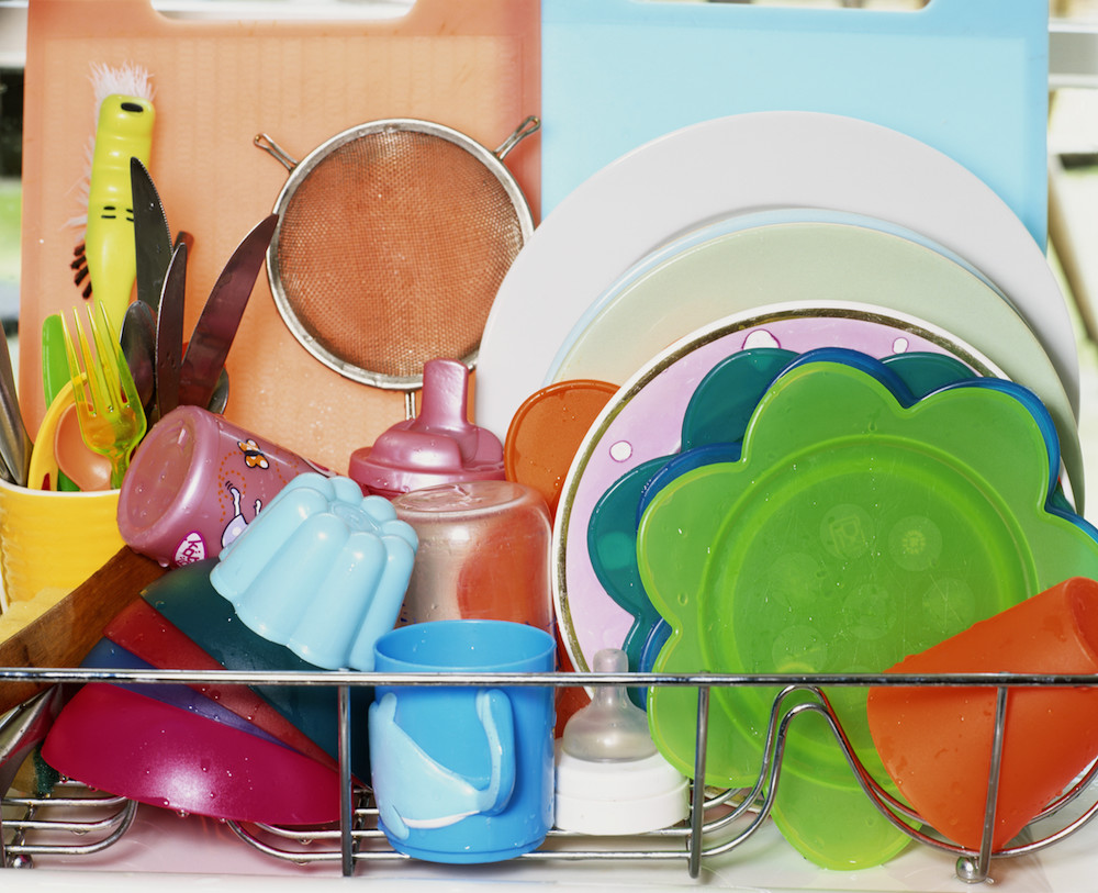 colourful plastic dishes drying on rack