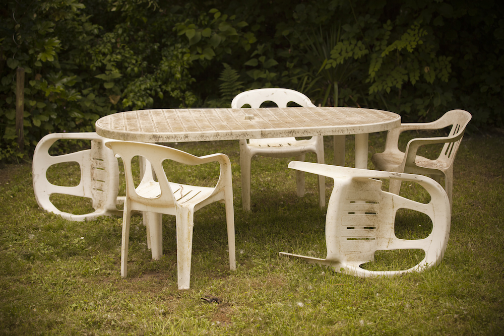 old white plastic outdoor table and chairs on green grass