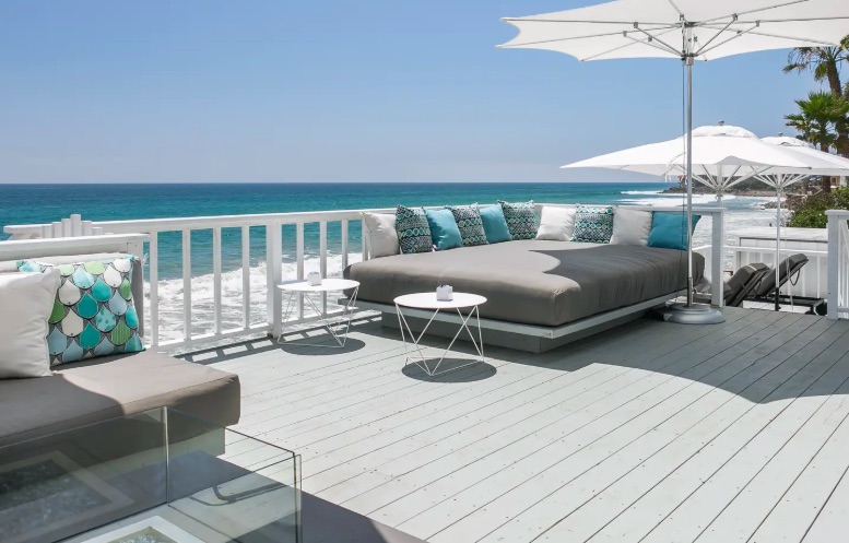 A 1,000-square-foot deck with jacuzzi, fronted by a private beach