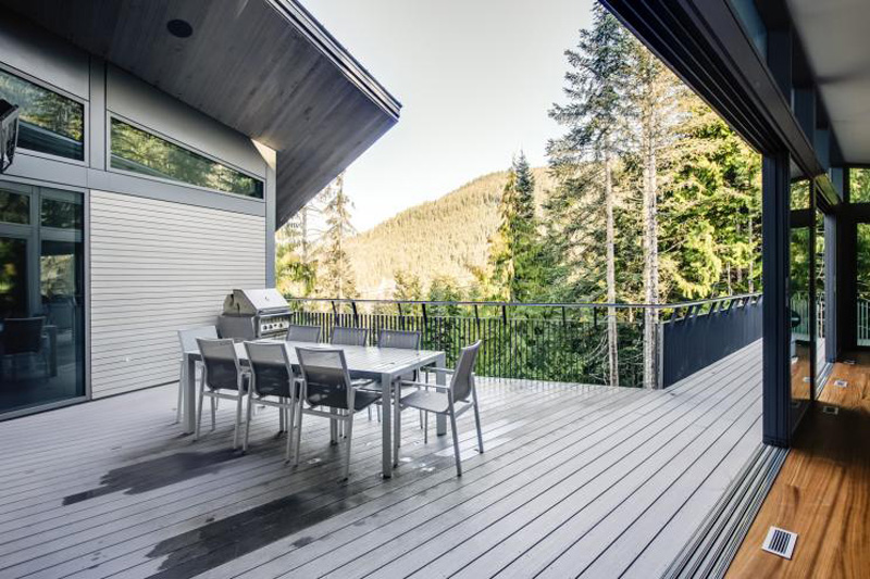 Large patio overlooking the green mountain ranges of British Columbia
