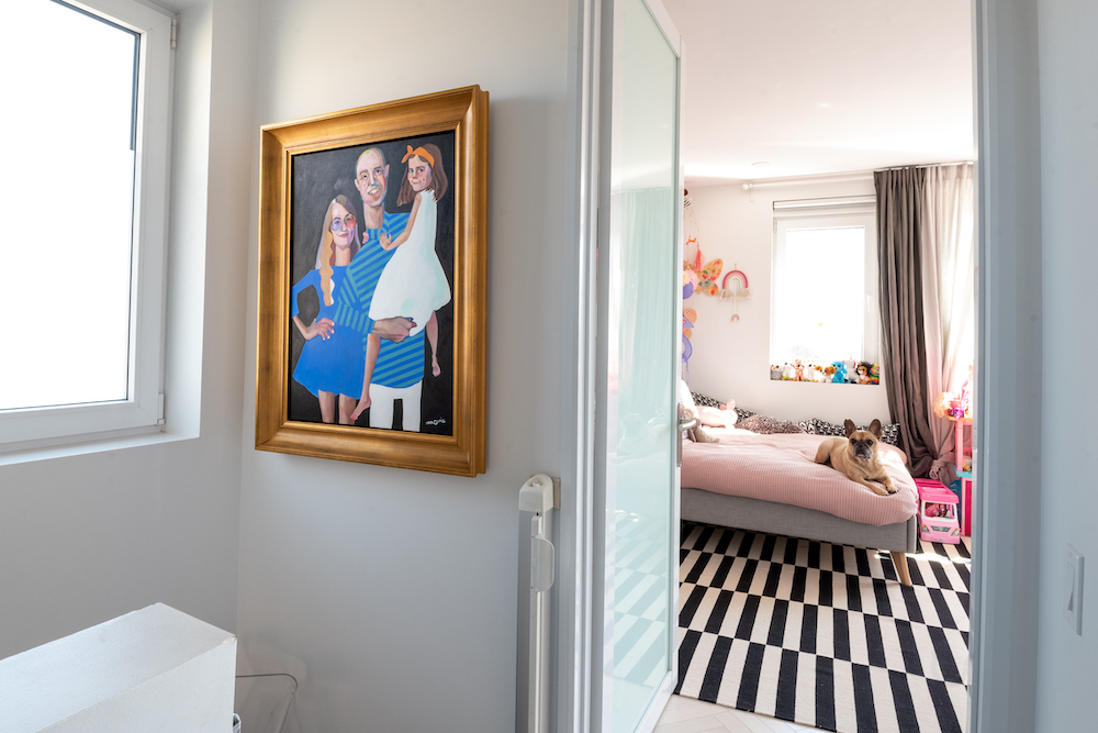 framed image of family with door into child's bedroom in background