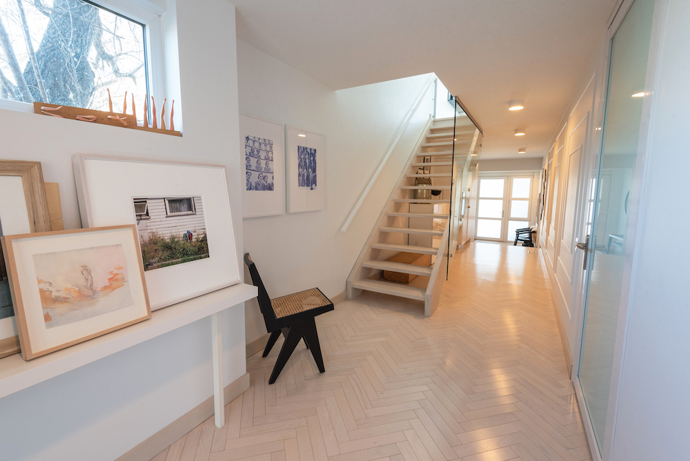 modern staircase with framed art on walls