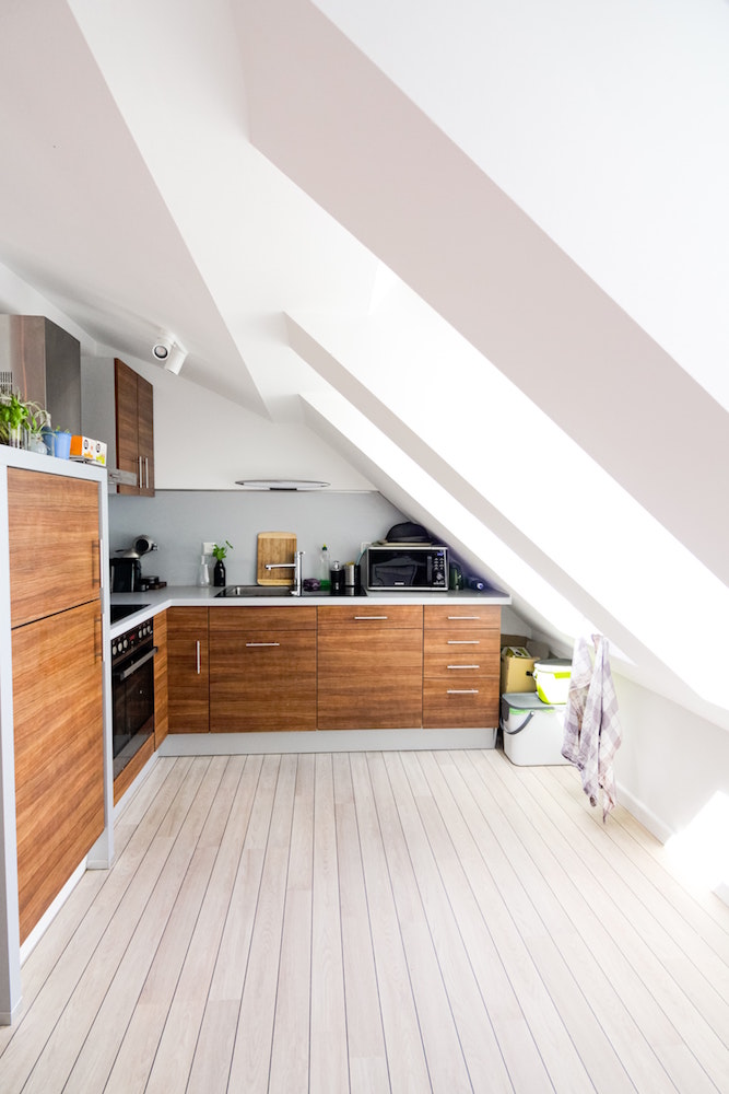 white and wood kitchen with angled roof on one side