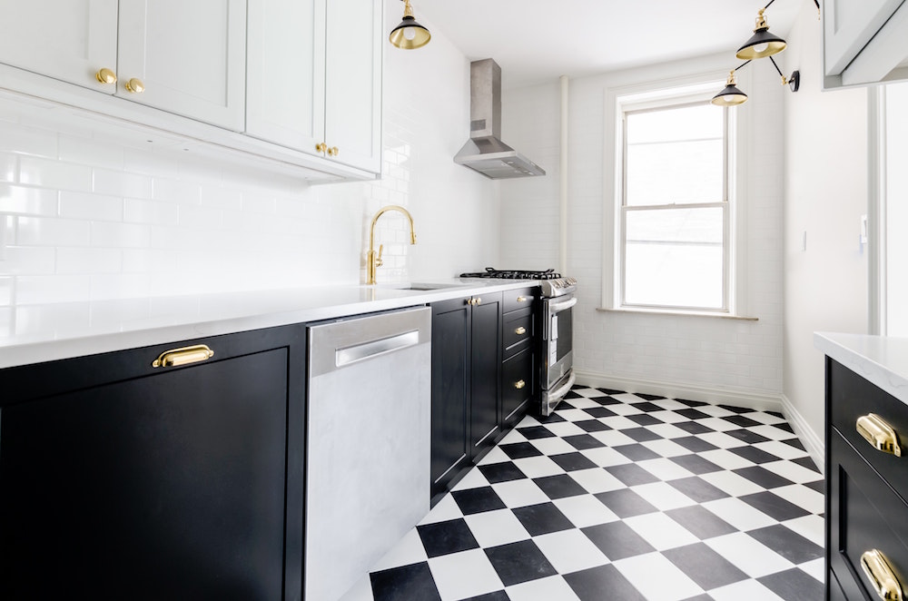 black and white kitchen with checkered floor