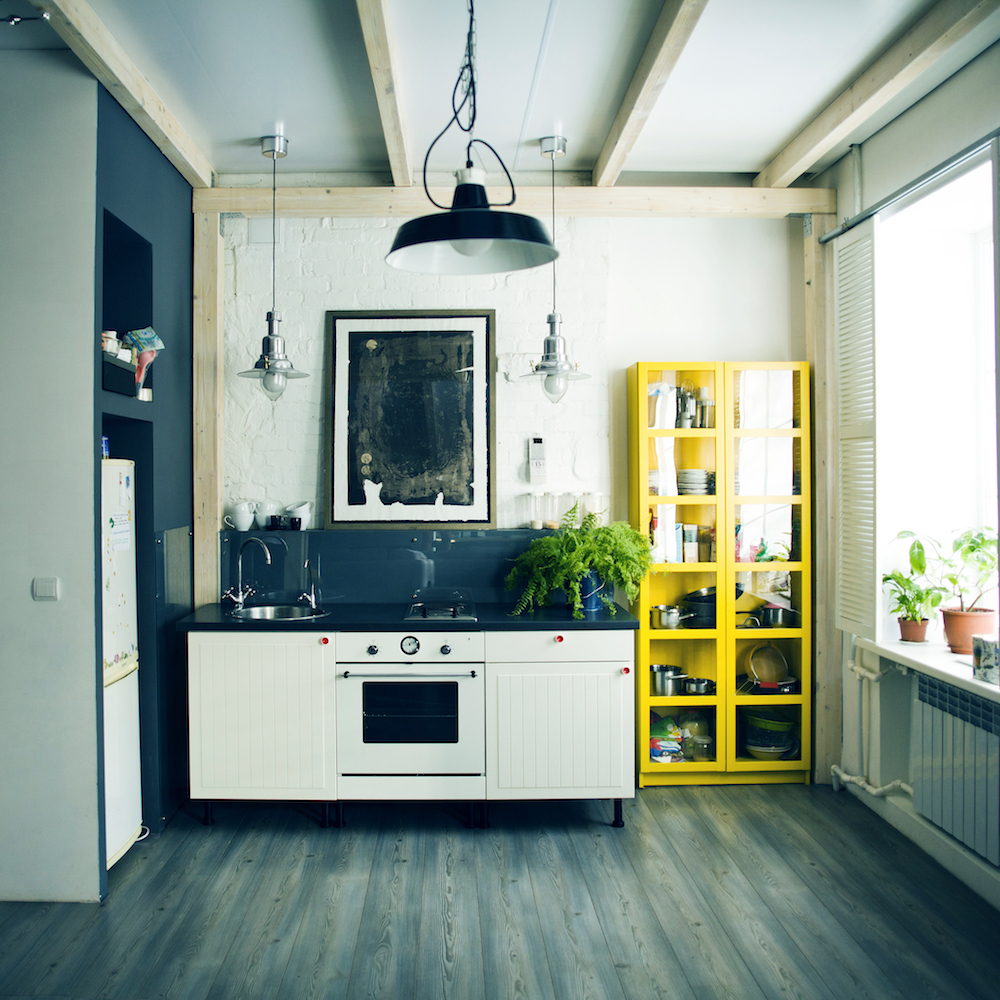 apartment kitchen with yellow shelf unit
