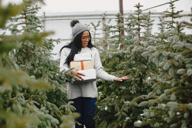 Woman buying a Christmas tree from a farm 