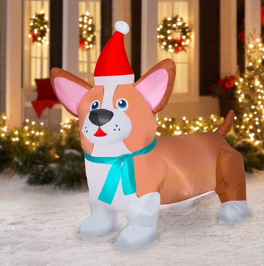 inflatable Christmas corgi decoration on snow in front of house