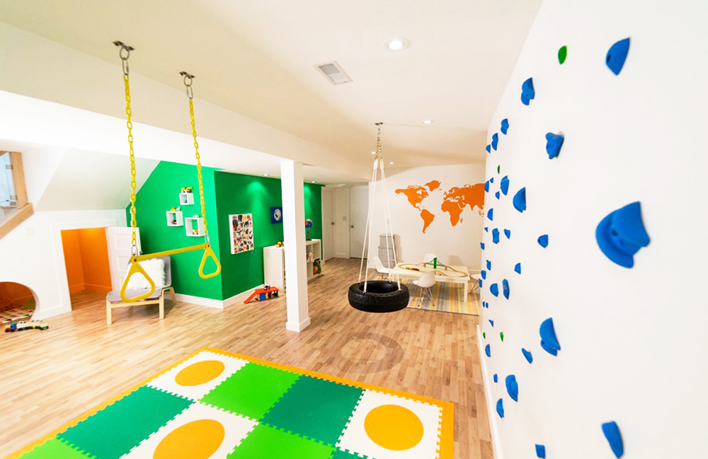 A brightly coloured gender-neutral kids playspace in the basement