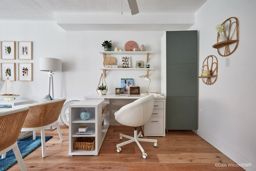 A small, neatly organized office nook off to the side of an open-concept dining room
