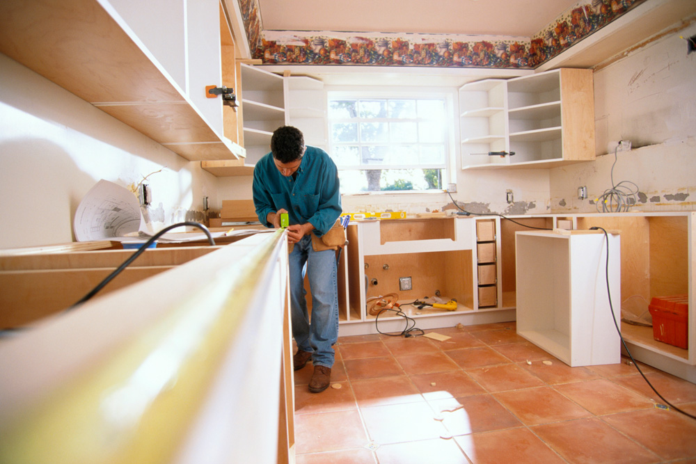 Worker renovating a kitchen