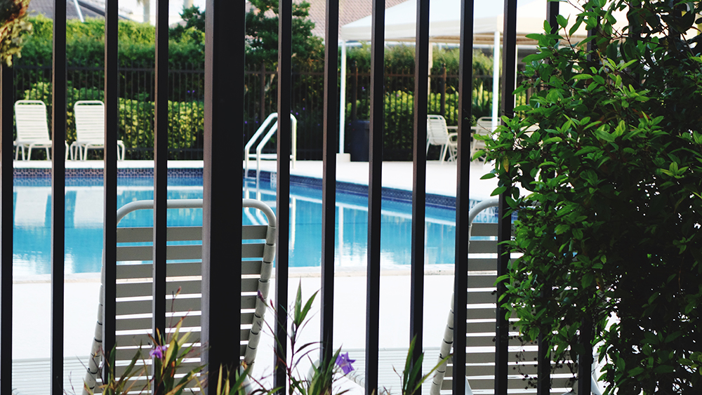 Black fence surrounding swimming pool
