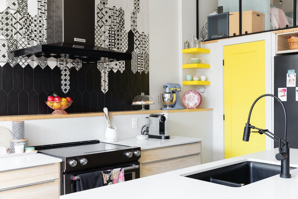 eclectic kitchen with black-and-white backsplash tile and yellow accents