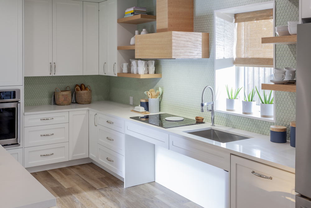 white kitchen with green penny tiles on backsplash
