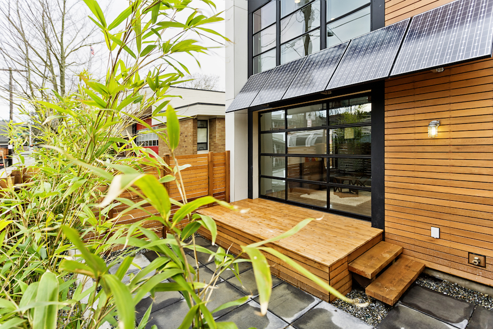 modern home exterior with solar panel awnings