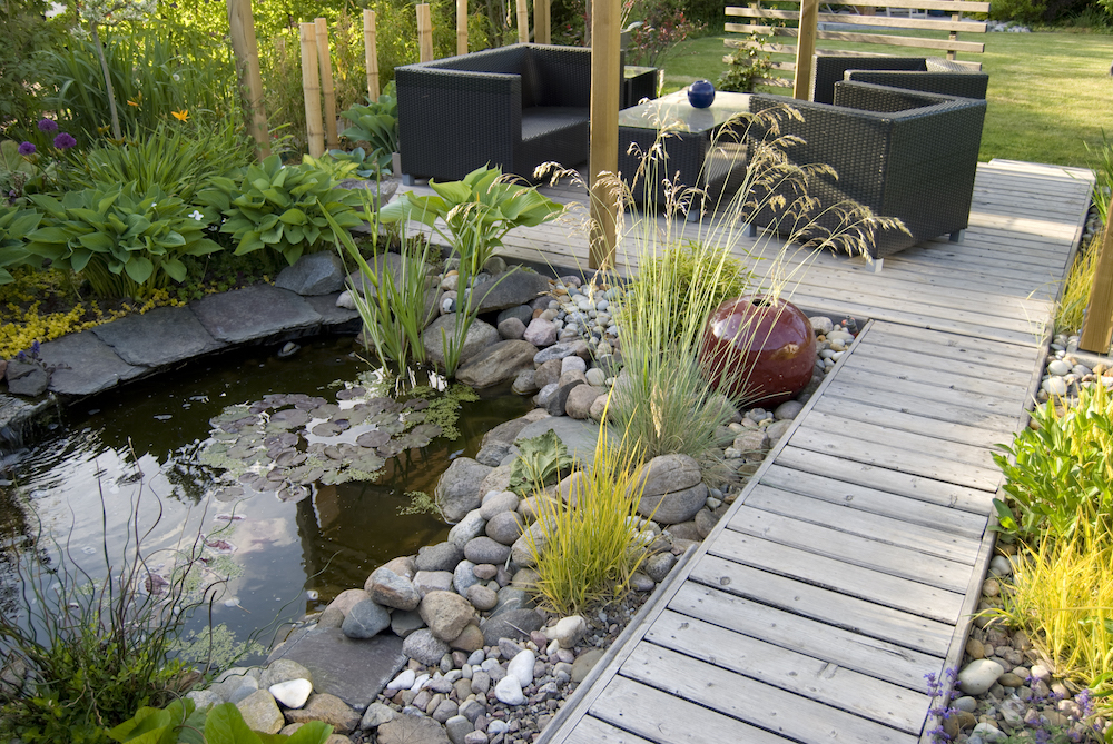 small backyard pond and a patio with a sitting area