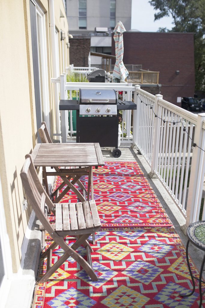 Balcony design with graphic outdoor rugs