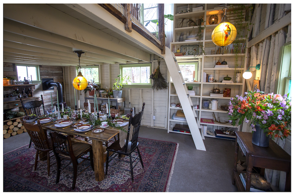 interior of rustic converted barn with dining area and loft