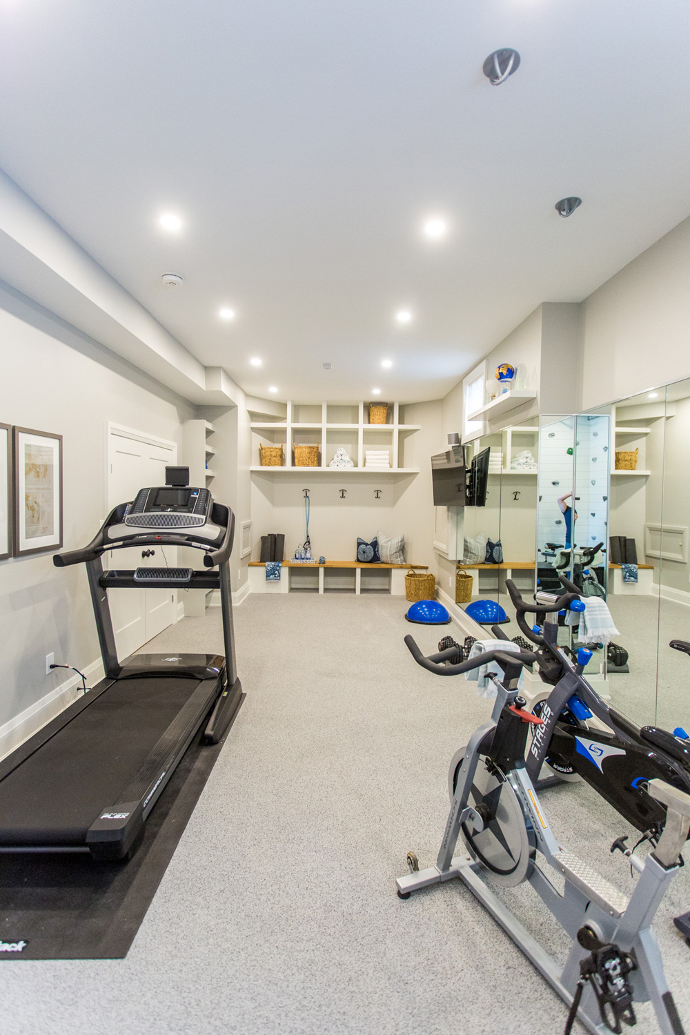 Home gym with treadmill and bike
