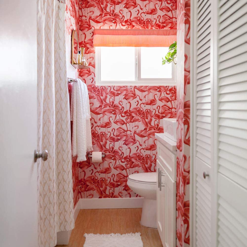 Fun flamingo wallpaper in bathroom with white accents